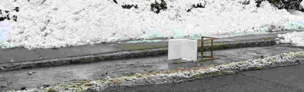 A OVERTURNED CHAIR IN A PARKING SPOT ACTING AS A SPACE SAVER SURROUNDED BEYE SLUS